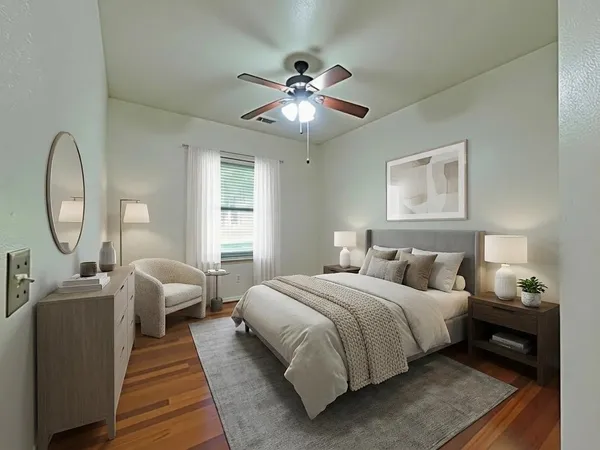 a bedroom with bed and a chandelier