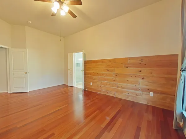 a view of an empty room and wooden floor