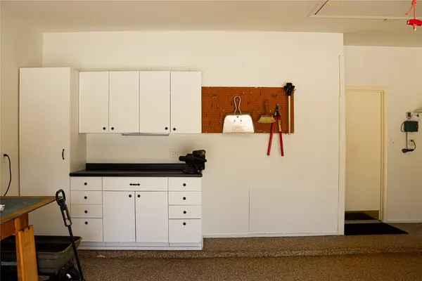 a room with white cabinets and a wooden floor