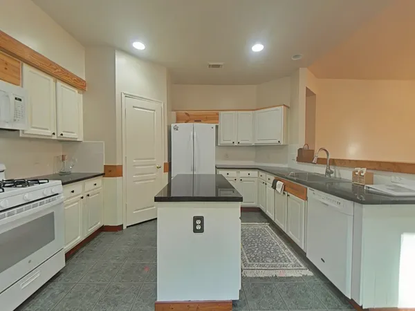 a kitchen with stainless steel appliances granite countertop a sink and cabinets