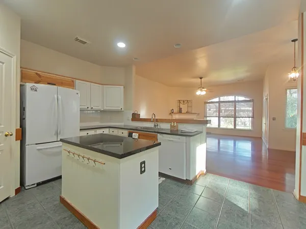 a kitchen with a stove a sink and a refrigerator