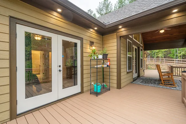 a view of a dining room and livingroom with furniture wooden floor a chandelier