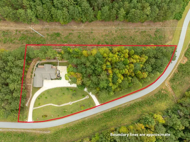 a bedroom with a large bed and wooden floor