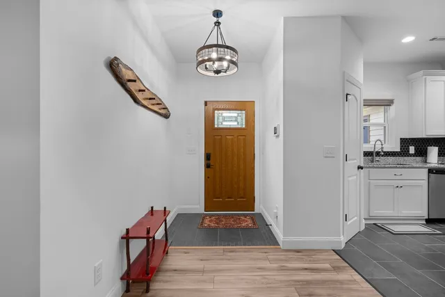a view of a swimming pool with a yard and large trees