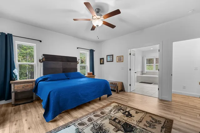 a view of a fire pit and a couple of cars parked on road