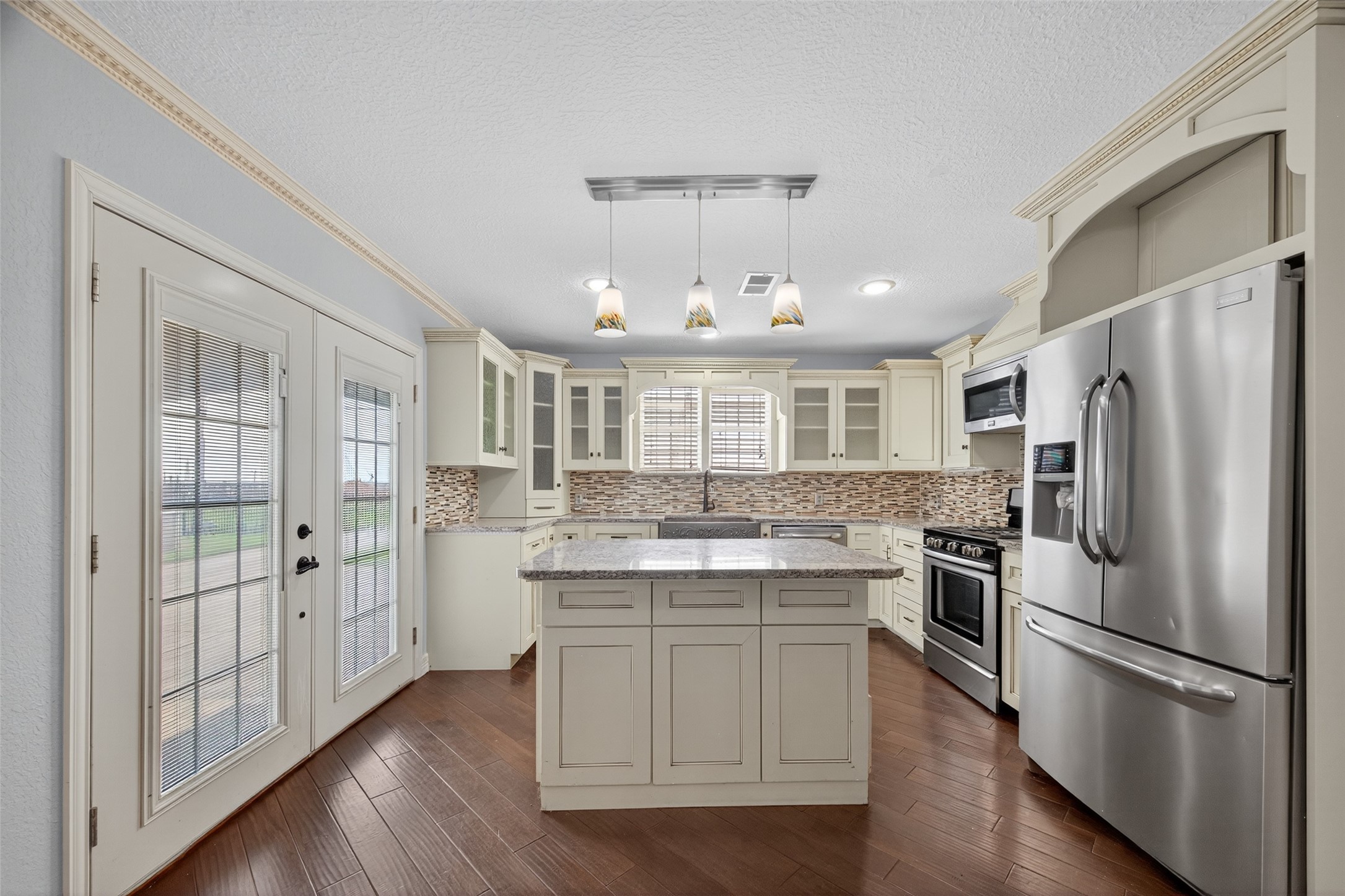 16809 Market Street Channelview, TX 77530 - Photo 12 of 35 a kitchen with kitchen island white cabinets and stainless steel appliances