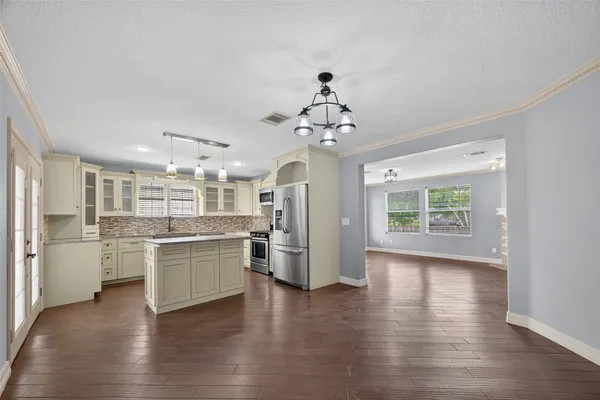 a kitchen with stainless steel appliances granite countertop a stove and refrigerator