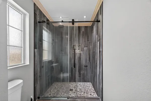 a bathroom with a shower and a mirror