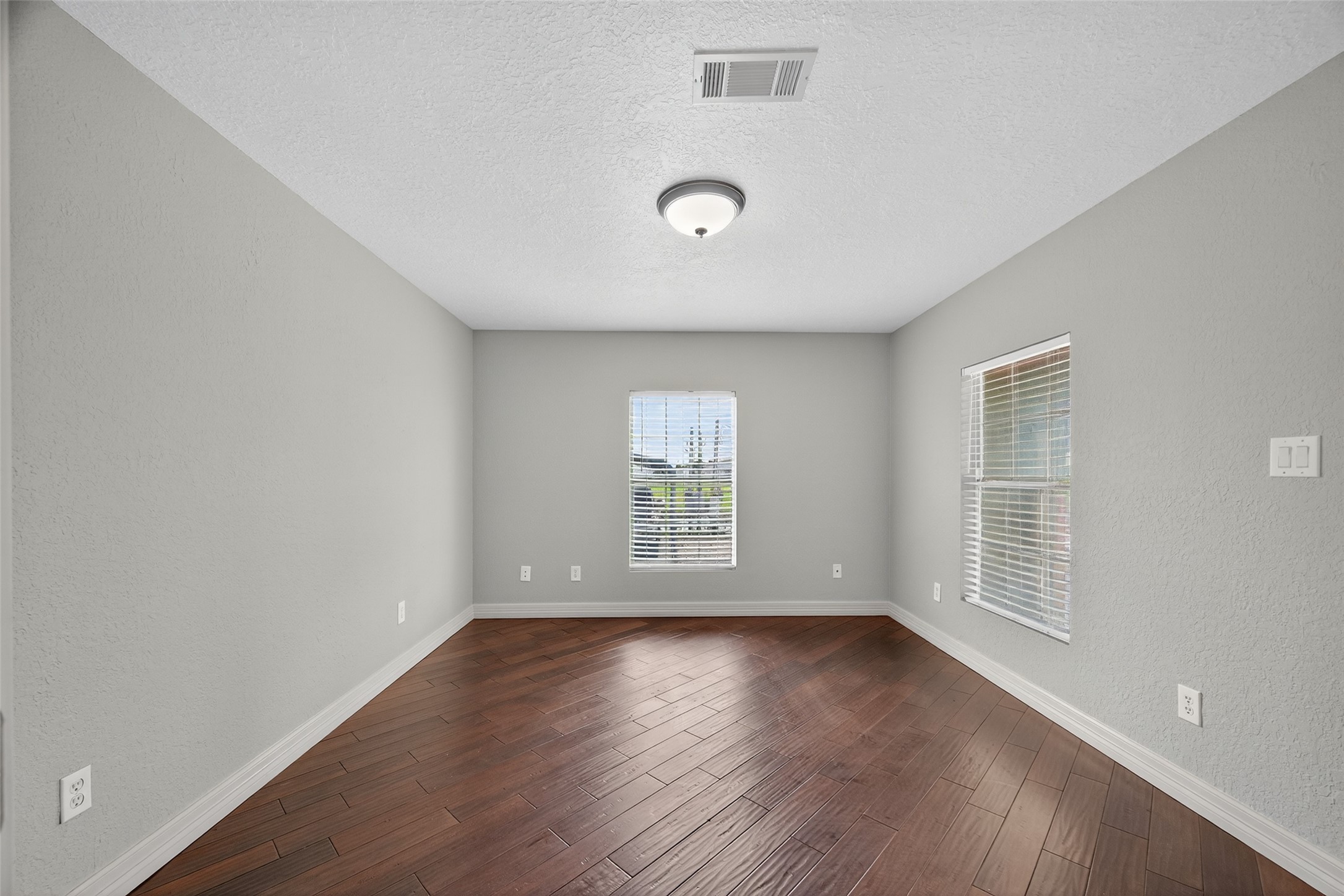 16809 Market Street Channelview, TX 77530 - Photo 25 of 35 an empty room with wooden floor and windows