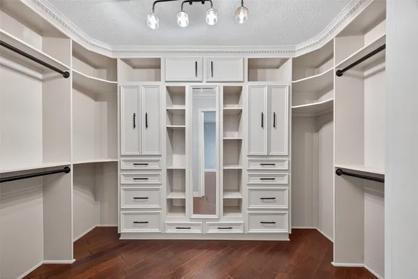 a view of walk in closet with empty racks