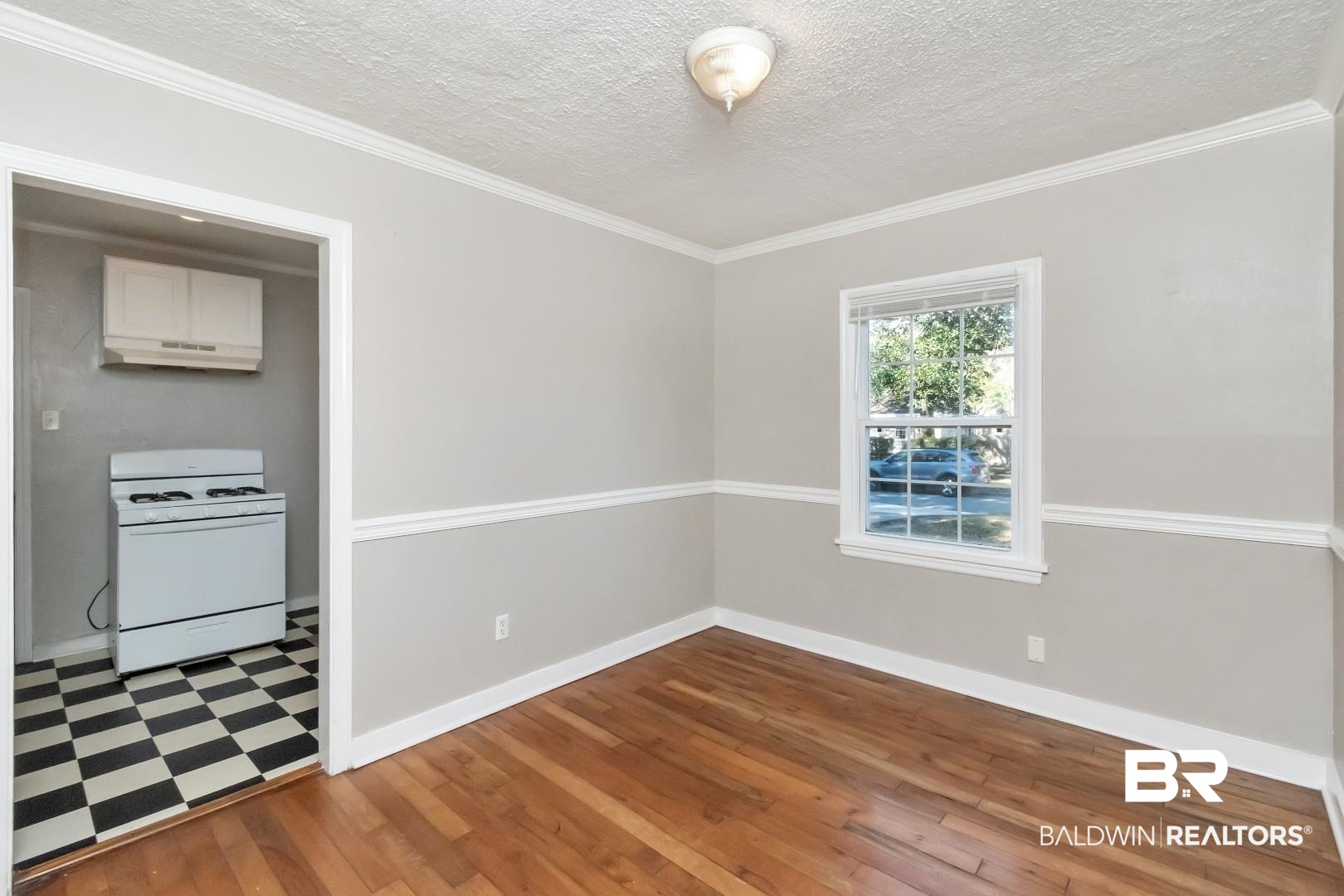 165 East Collins Street Mobile, AL 36606 - Photo 8 of 19 Unfurnished dining area with ornamental molding, wood finished floors, and baseboards