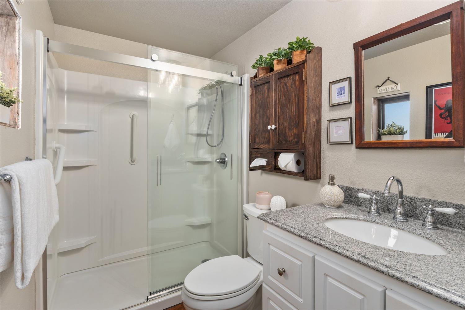 340 Tom Bell Road, Unit 259 Murphys, CA 95247 - Photo 17 of 43 Primary bathroom with walk-in shower, glass doors, custom lighting and fixtures.