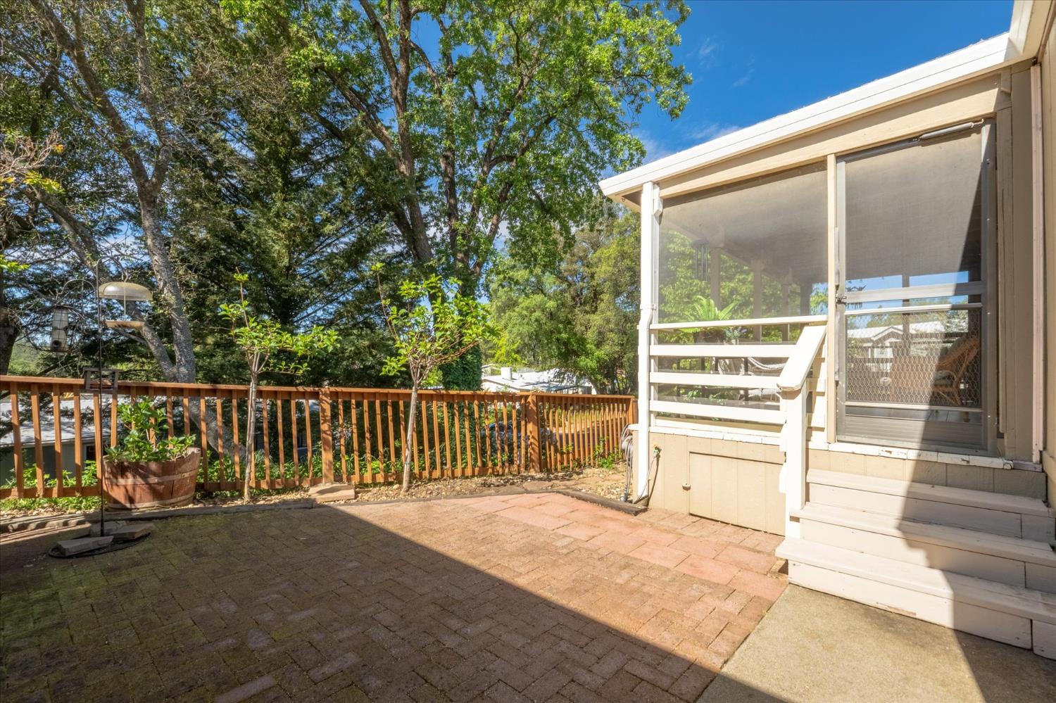 340 Tom Bell Road, Unit 259 Murphys, CA 95247 - Photo 23 of 43 Brick paver uncovered patio area in fenced backyard.