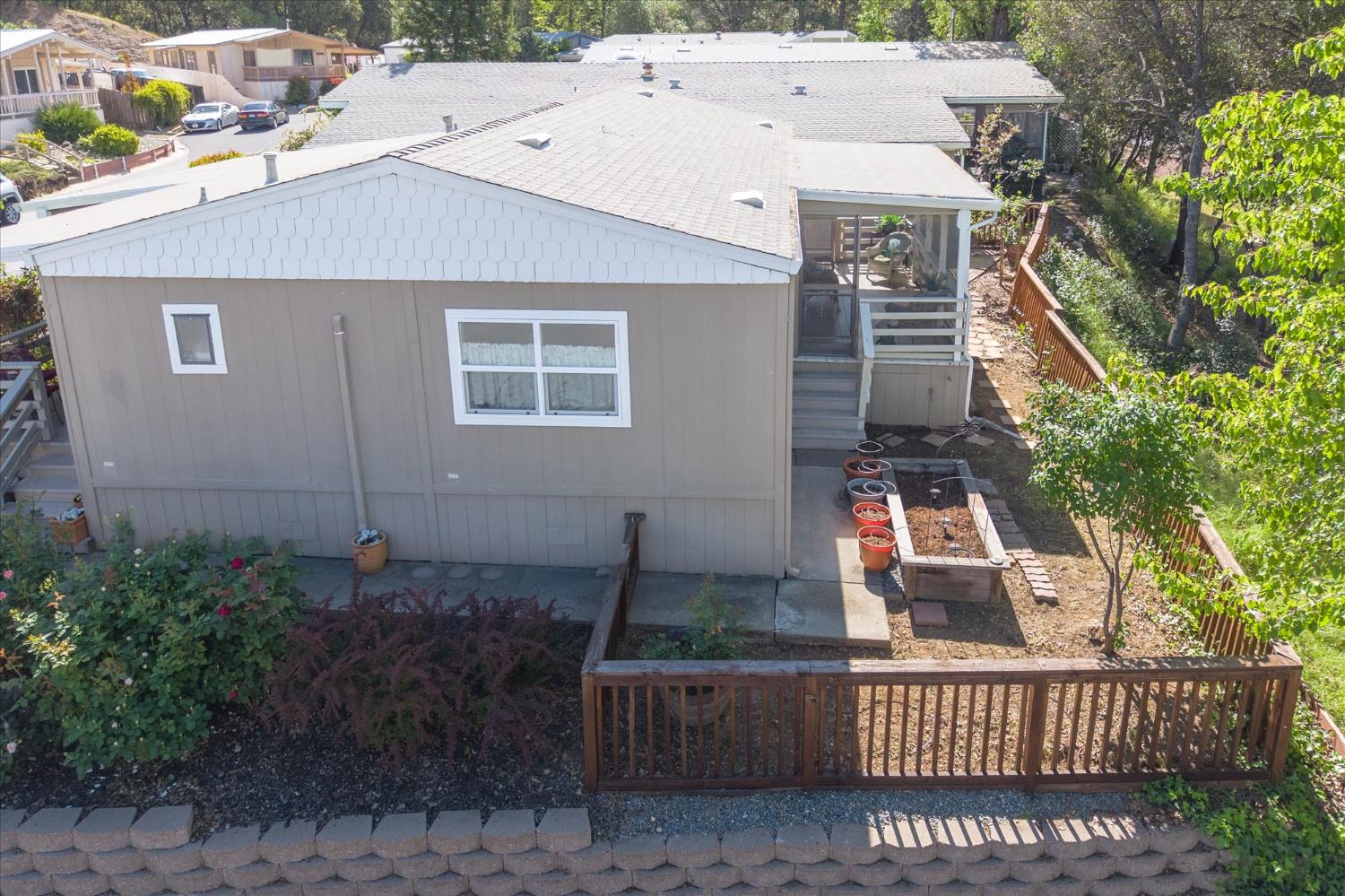 340 Tom Bell Road, Unit 259 Murphys, CA 95247 - Photo 25 of 43 Fenced backyard with boasts rose, lilac and hydrangea plants. Plus raised bed garden and screened in back deck.