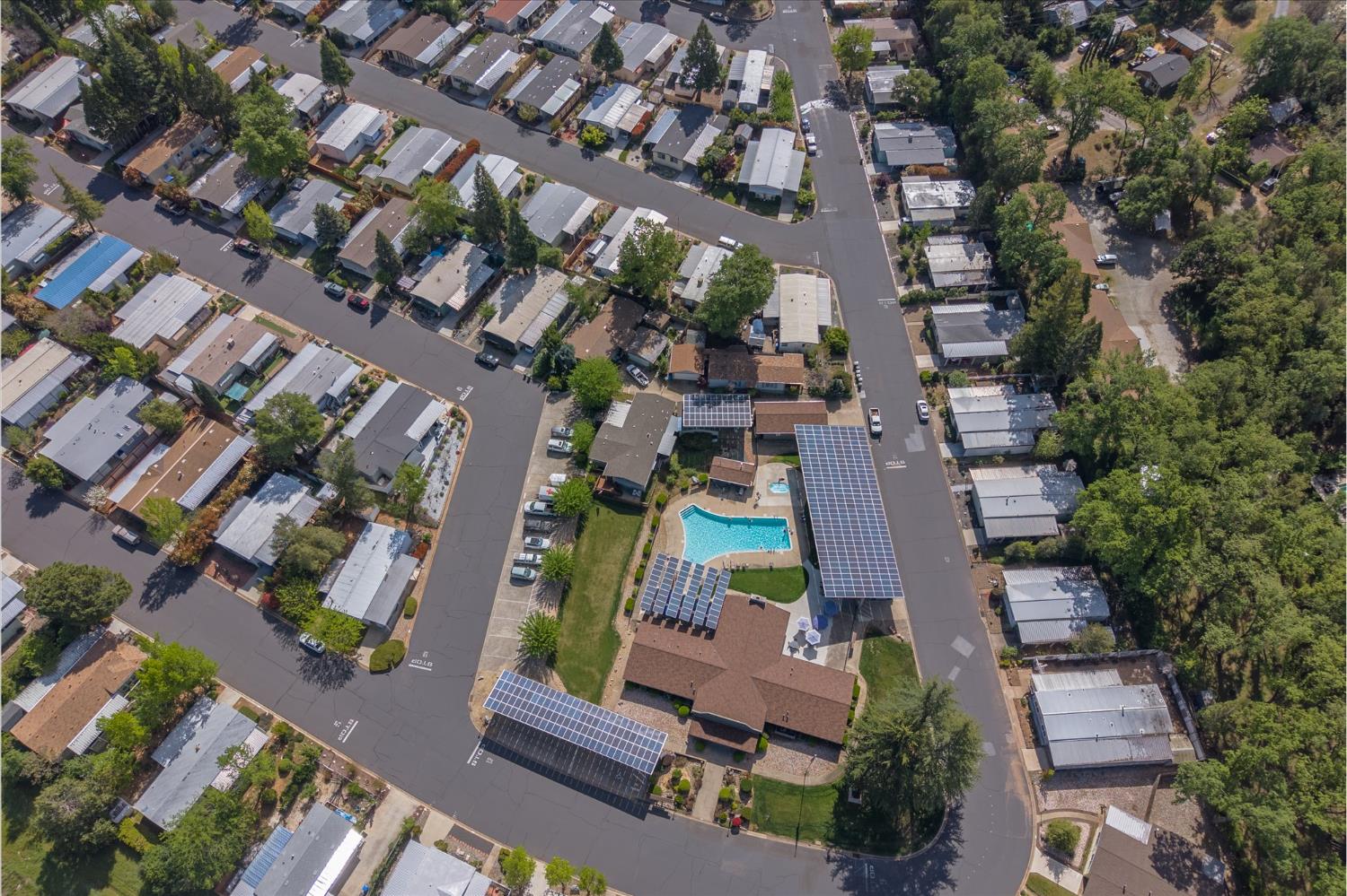 340 Tom Bell Road, Unit 259 Murphys, CA 95247 - Photo 33 of 43 Aerial view of community pool and clubhouse. Below the the right solar panels are the covered community mailboxes.