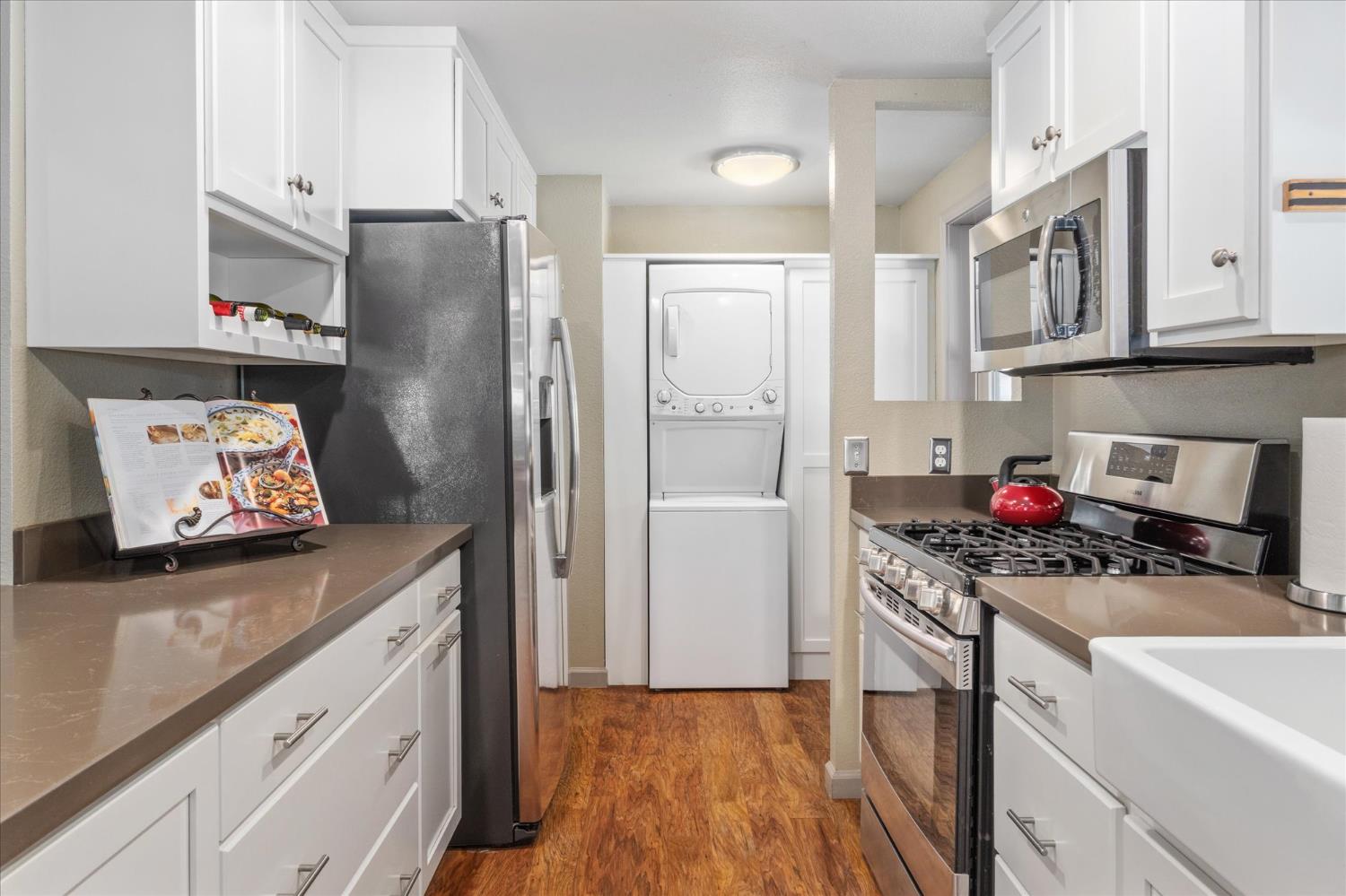 340 Tom Bell Road, Unit 259 Murphys, CA 95247 - Photo 7 of 43 Kitchen features a built-in wine rack, a custom pull out spice drawer, pantry cabinet and easy-access pull-out shelves. Laundry area with stacked washer and dryer accessed from kitchen.