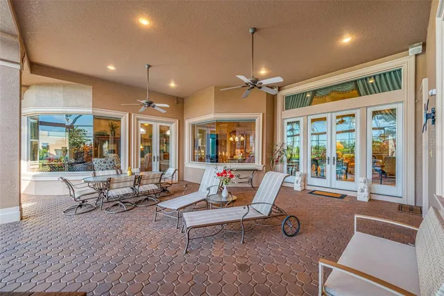 a view of a patio with table and chairs under an umbrella