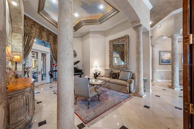a living room with furniture a fireplace and a large window