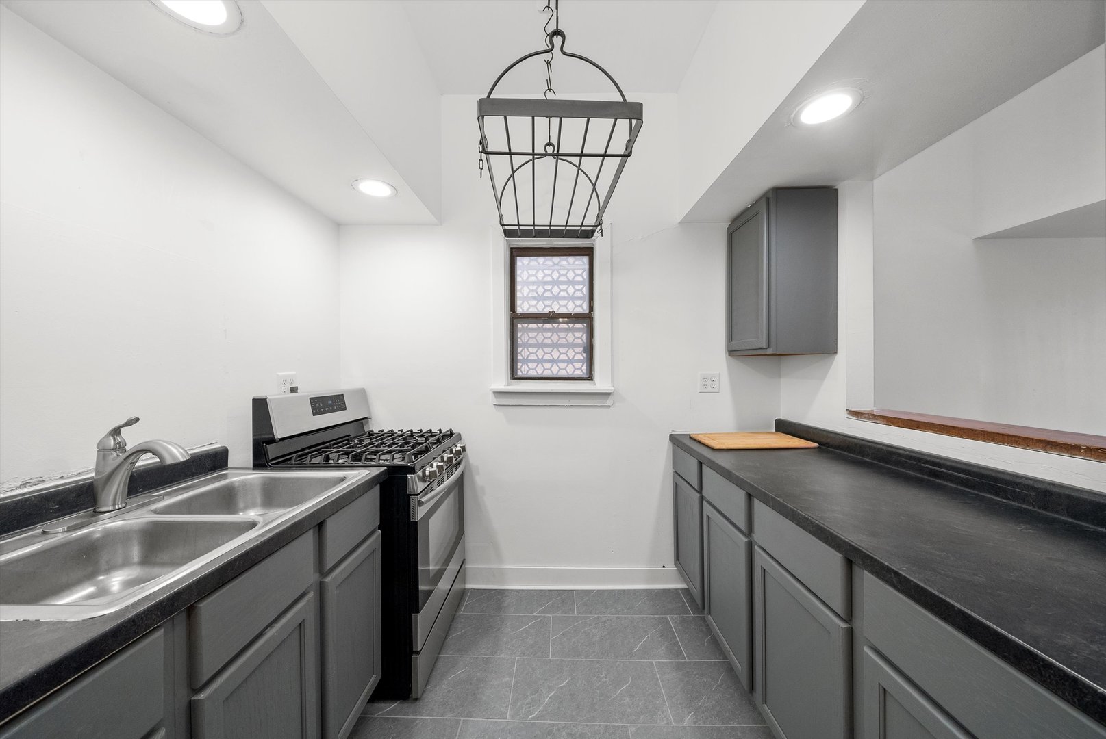 903 West 19th Street, Unit 3 Chicago, IL 60608 - Photo 8 of 16 a kitchen with stainless steel appliances granite countertop a sink a stove and a wooden floors