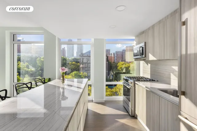 a view of a dining room with furniture and a window