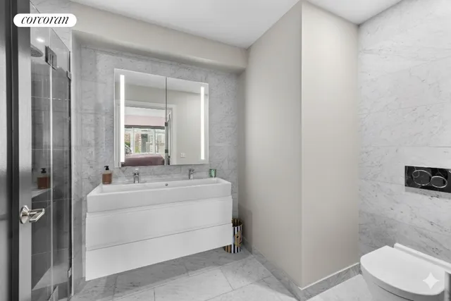 a bedroom with bed a lamp and a large window with the outer view