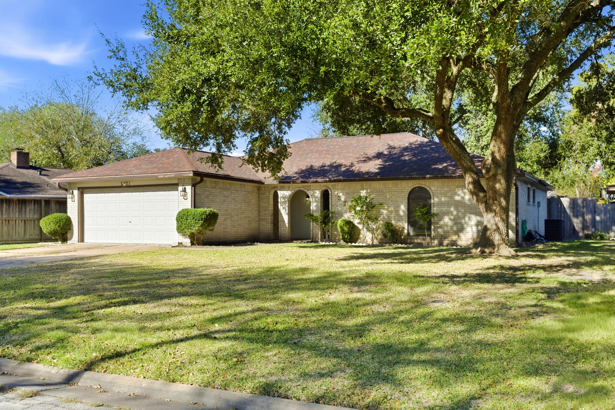 3721 Avenue R Rosenberg, TX 77471 - Photo 4 of 43 Spacious front yard with large oak tree offering shade and character in an established neighborhood.