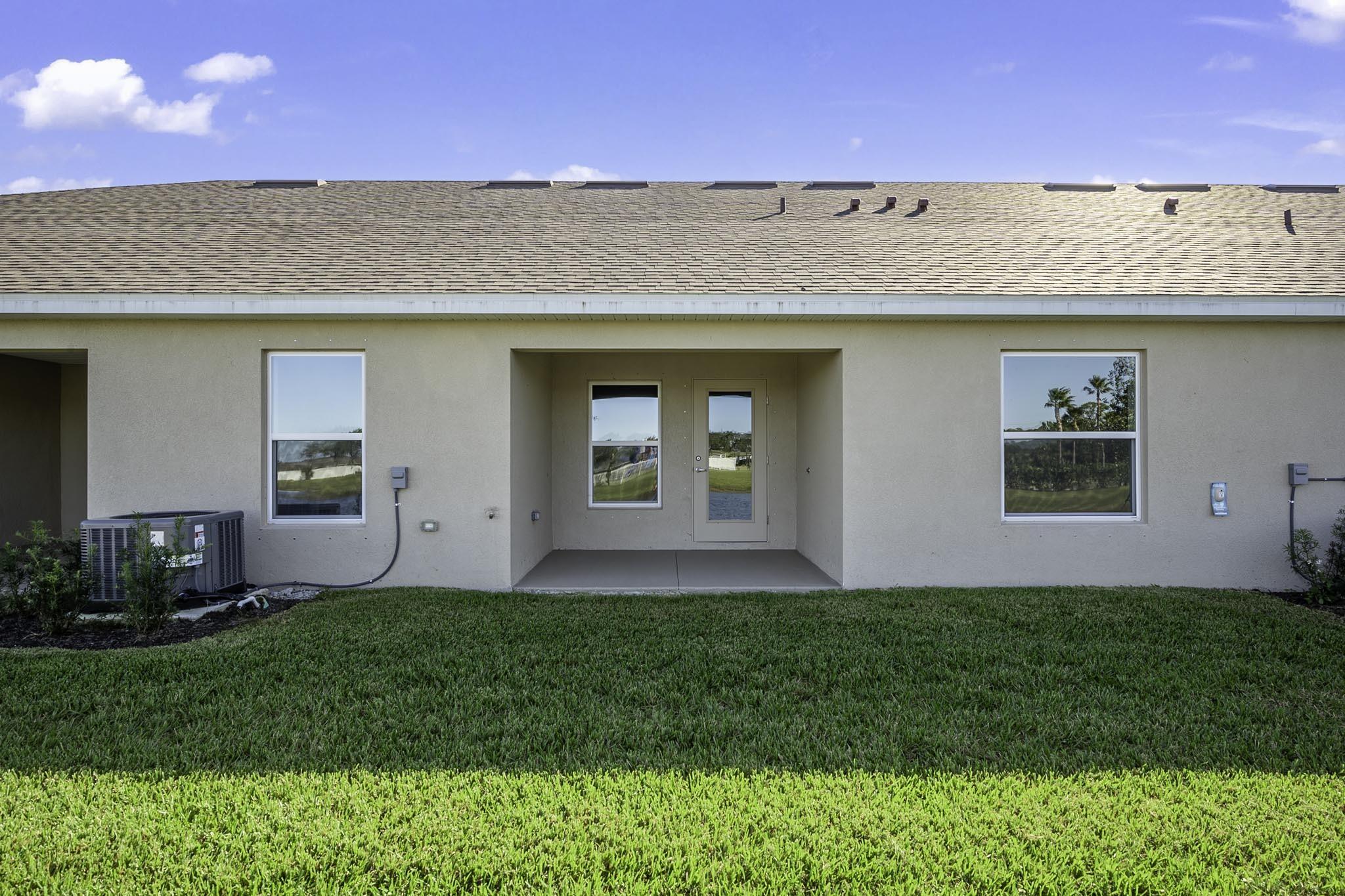 8634 Modeno Street Fort Pierce, FL 34951 - Photo 19 of 34 a front view of a house with a yard