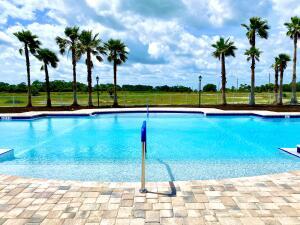 8634 Modeno Street Fort Pierce, FL 34951 - Photo 29 of 34 a view of a swimming pool and a yard