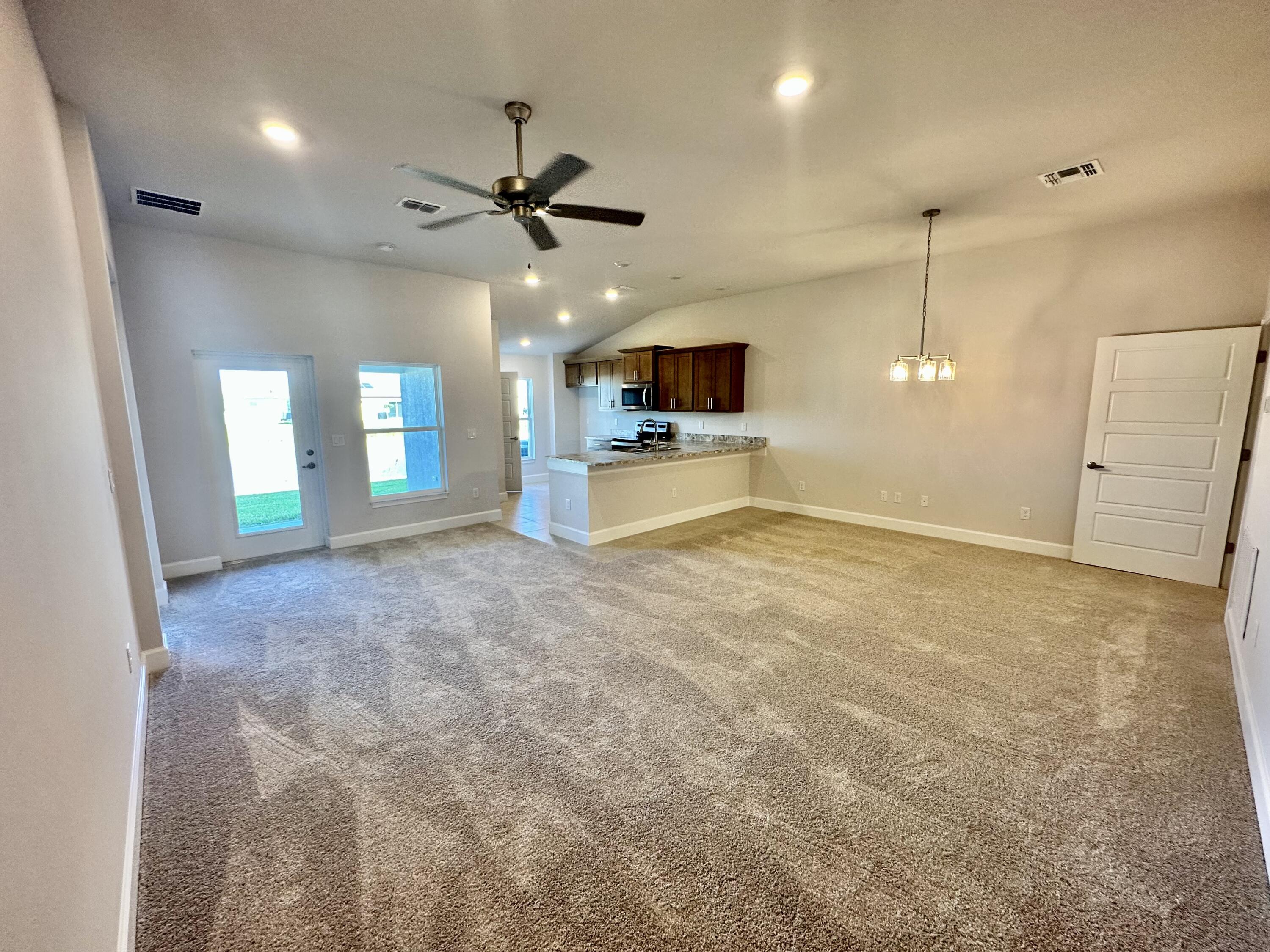 8634 Modeno Street Fort Pierce, FL 34951 - Photo 5 of 34 a view of a livingroom with a ceiling fan and window