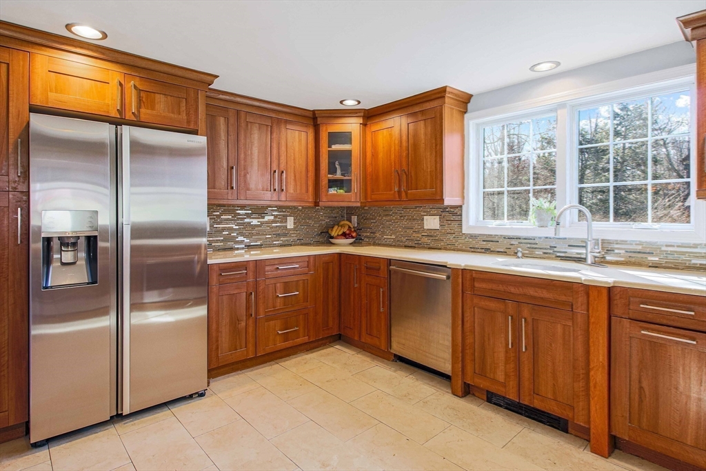 5 Old Brook Drive Worcester, MA 01609 - Photo 26 of 42 a kitchen with stainless steel appliances granite countertop a refrigerator and wooden cabinets