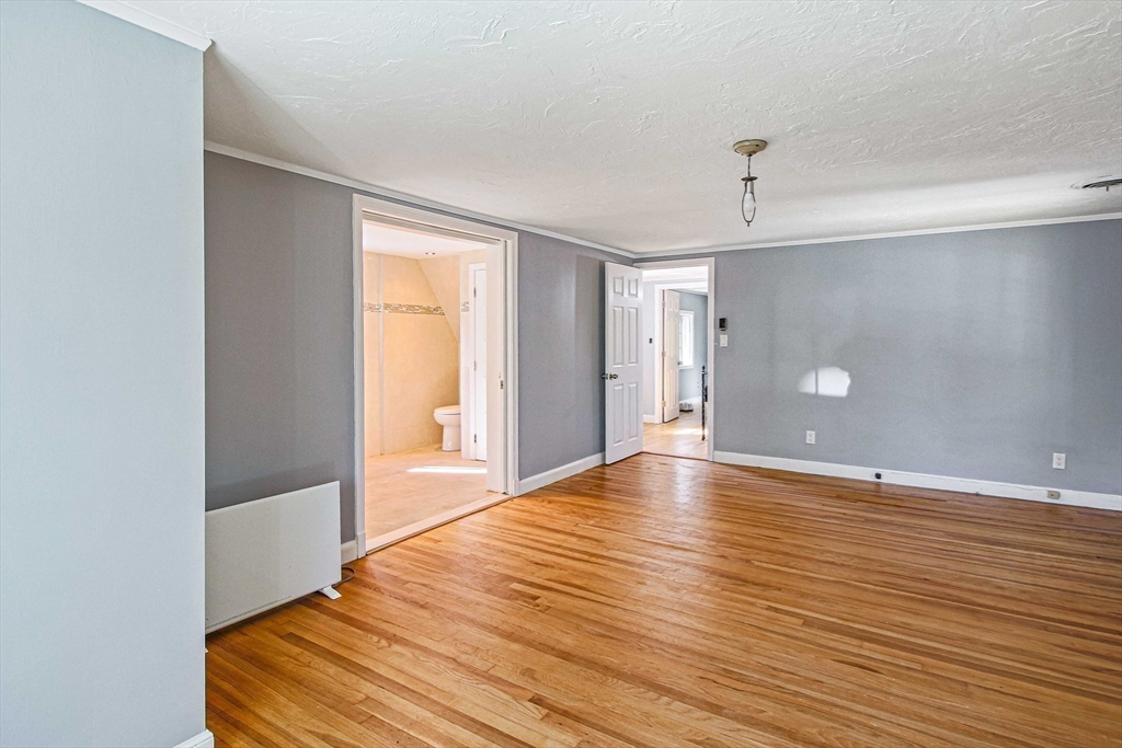 5 Old Brook Drive Worcester, MA 01609 - Photo 34 of 42 a view of an empty room with window and wooden floor