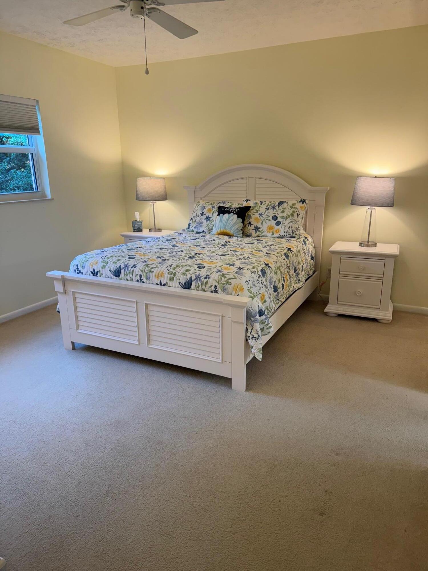 2950 Southeast Ocean Boulevard, Unit 110202 Stuart, FL 34996 - Photo 12 of 25 a bedroom with a bed and a night stand