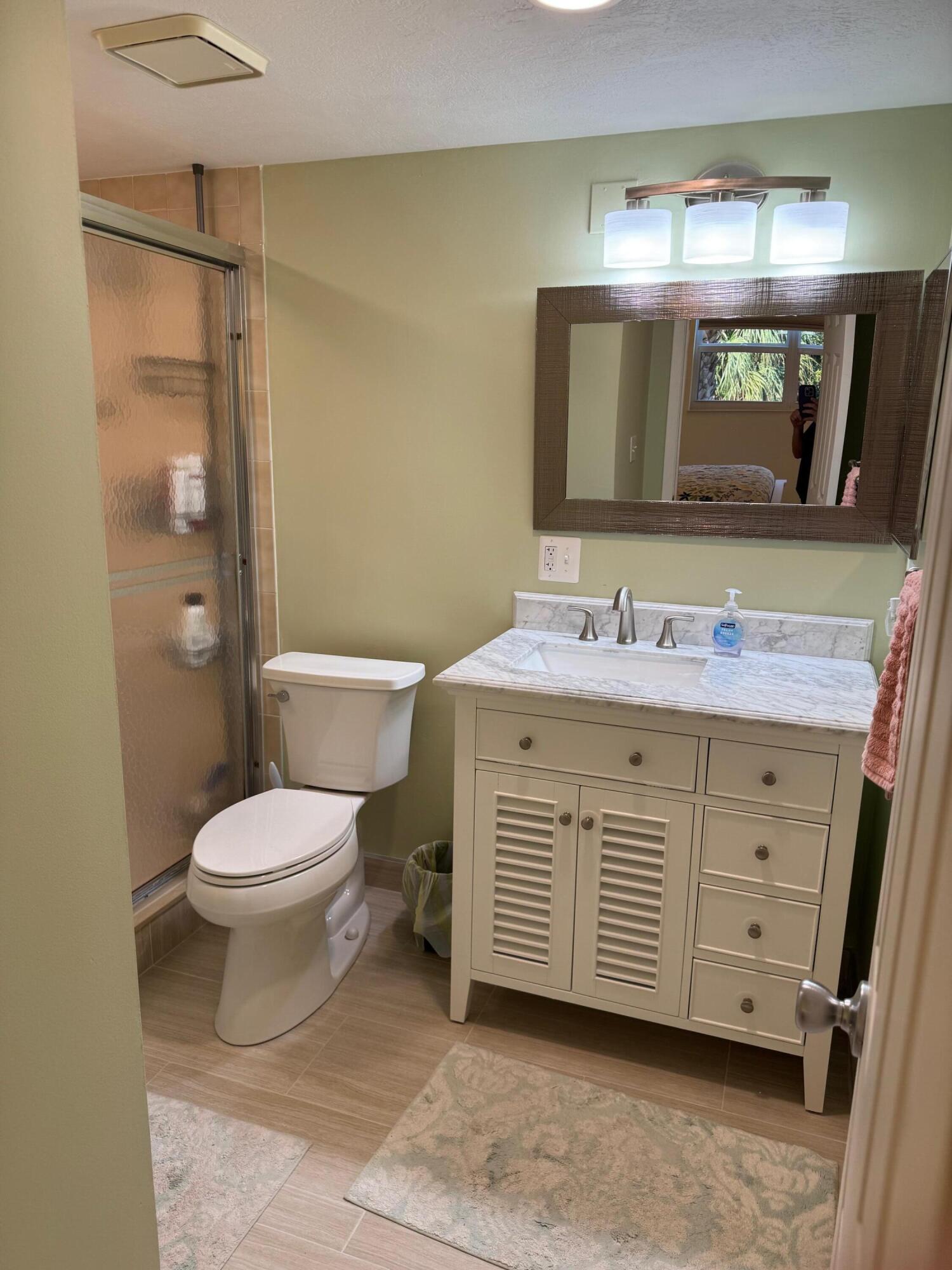 2950 Southeast Ocean Boulevard, Unit 110202 Stuart, FL 34996 - Photo 16 of 25 a bathroom with a sink and a mirror
