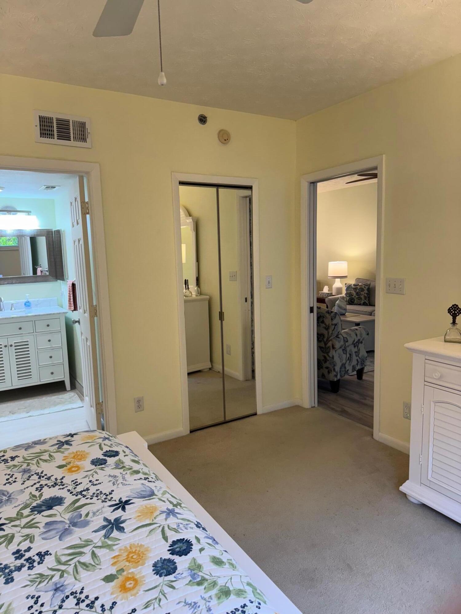 2950 Southeast Ocean Boulevard, Unit 110202 Stuart, FL 34996 - Photo 17 of 25 a bedroom with a bed and a couch