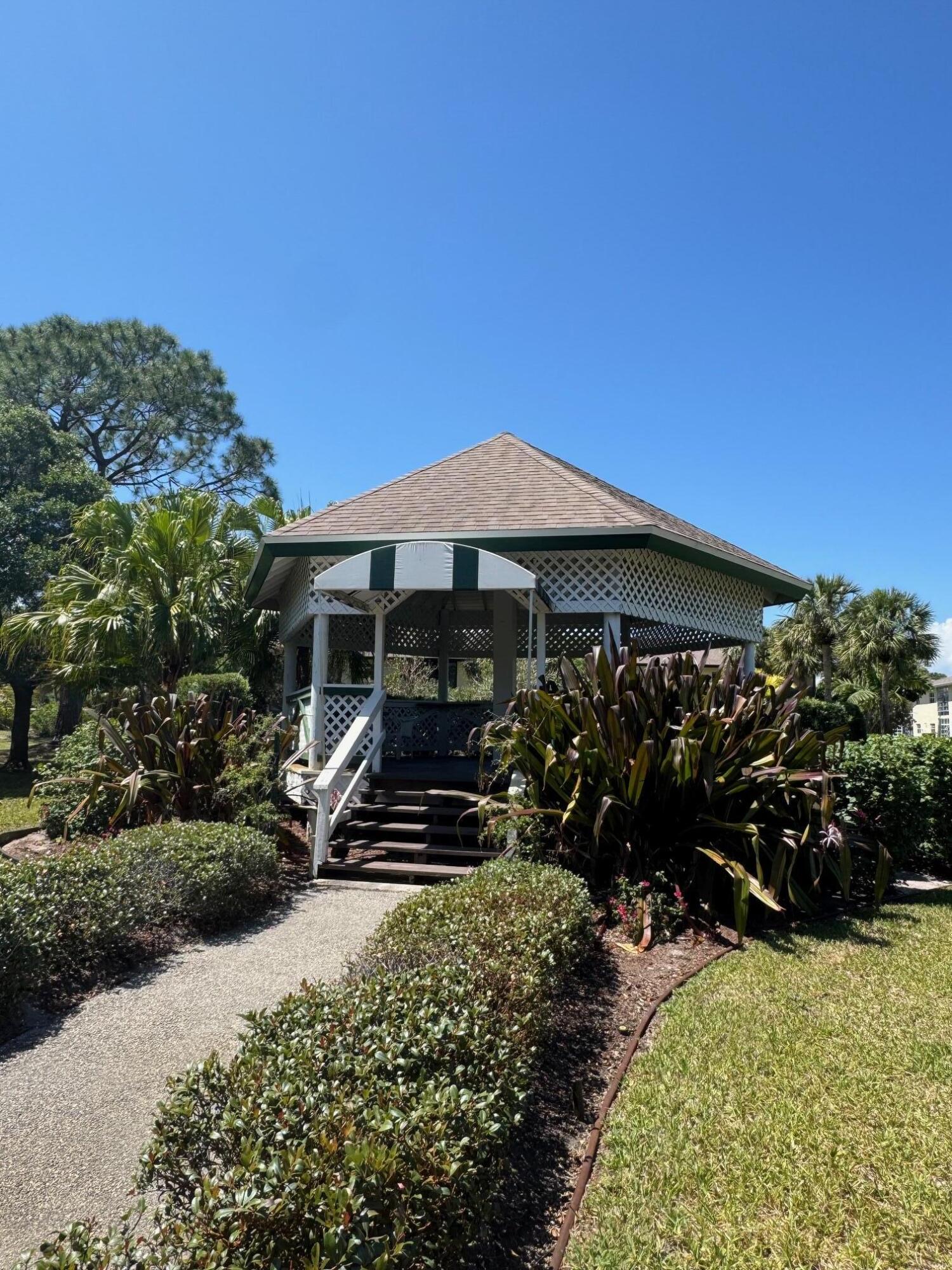 2950 Southeast Ocean Boulevard, Unit 110202 Stuart, FL 34996 - Photo 23 of 25 a front view of a house with a yard