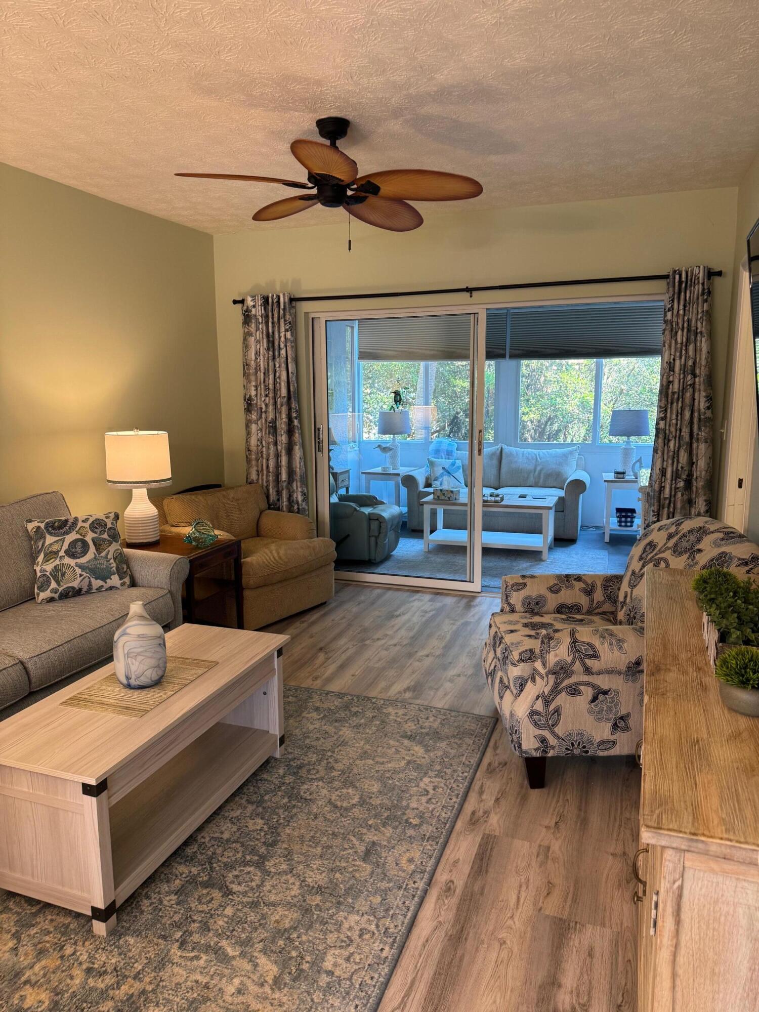 2950 Southeast Ocean Boulevard, Unit 110202 Stuart, FL 34996 - Photo 7 of 25 a living room with furniture and a flat screen tv