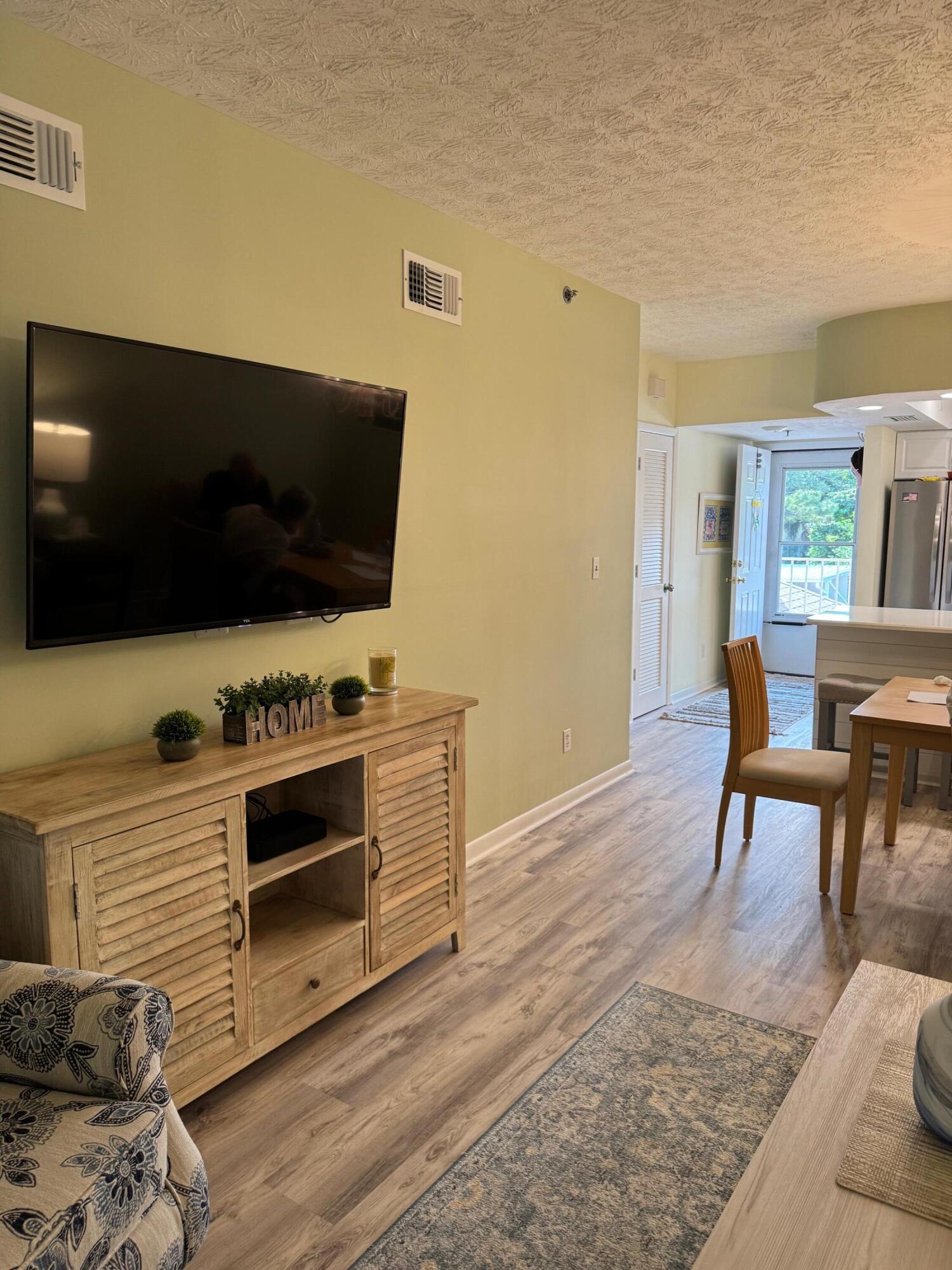 2950 Southeast Ocean Boulevard, Unit 110202 Stuart, FL 34996 - Photo 8 of 25 a view of livingroom with furniture and flat screen tv