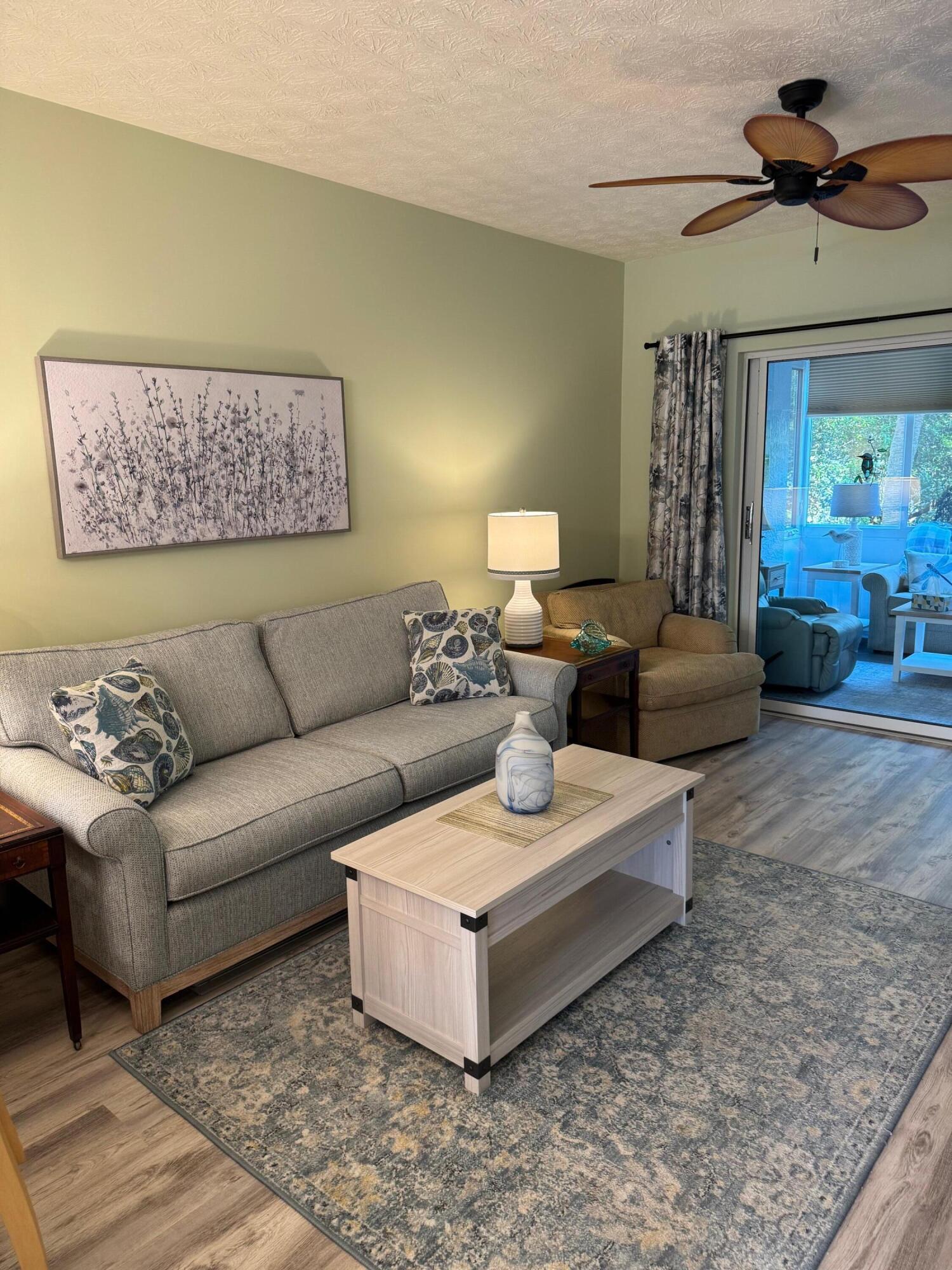 2950 Southeast Ocean Boulevard, Unit 110202 Stuart, FL 34996 - Photo 9 of 25 a living room with furniture and a ceiling fan