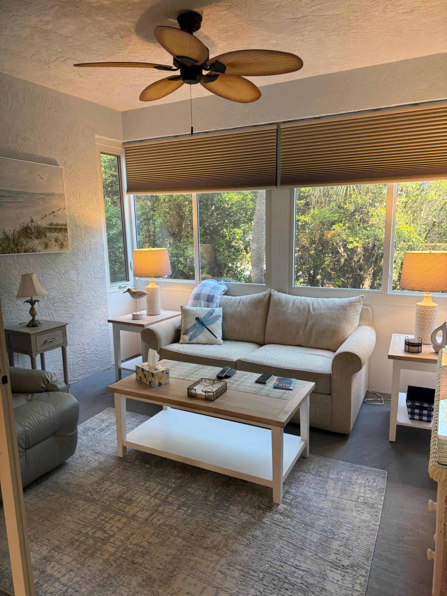 2950 Southeast Ocean Boulevard, Unit 110202 Stuart, FL 34996 - Photo 10 of 25 a living room with furniture and a window