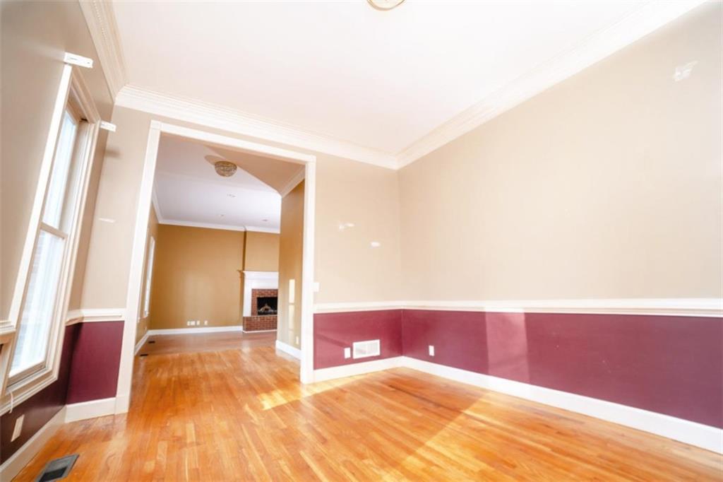 2210 Cammie Wages Road Dacula, GA 30019 - Photo 11 of 32 a view of a room with wooden floor and a large window
