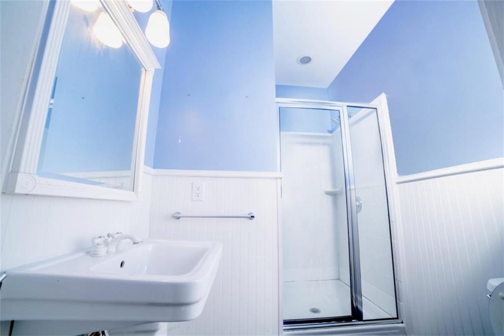 2210 Cammie Wages Road Dacula, GA 30019 - Photo 18 of 32 a bathroom with a sink a mirror and shower