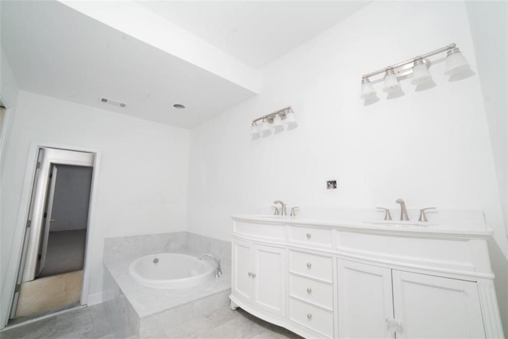 2210 Cammie Wages Road Dacula, GA 30019 - Photo 22 of 32 a bathroom with a sink and a bathtub