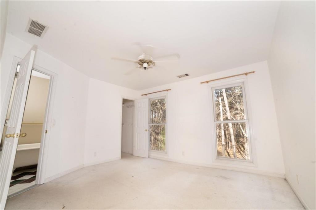 2210 Cammie Wages Road Dacula, GA 30019 - Photo 26 of 32 a view of an empty room with closet and windows