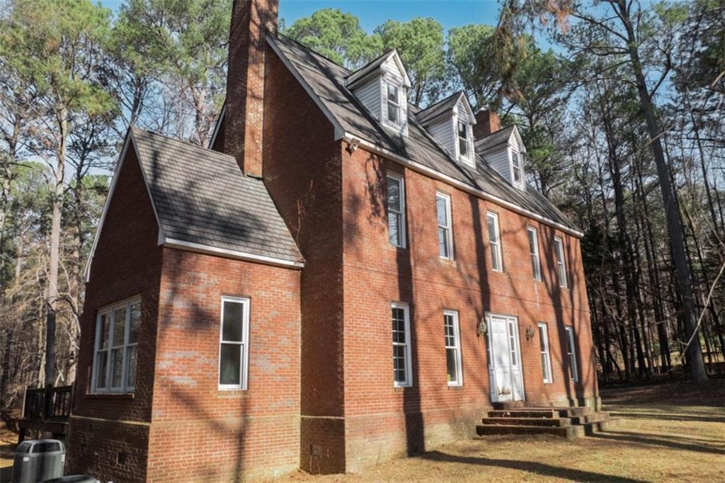 2210 Cammie Wages Road Dacula, GA 30019 - Photo 4 of 32 a view of a large building with large tree