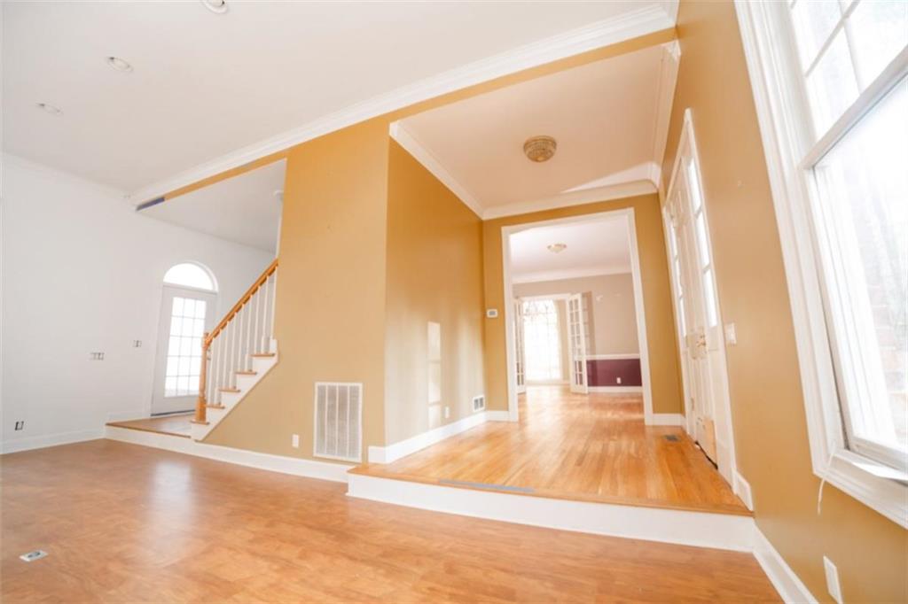 2210 Cammie Wages Road Dacula, GA 30019 - Photo 8 of 32 a view of a hallway to a house with wooden floor and windows