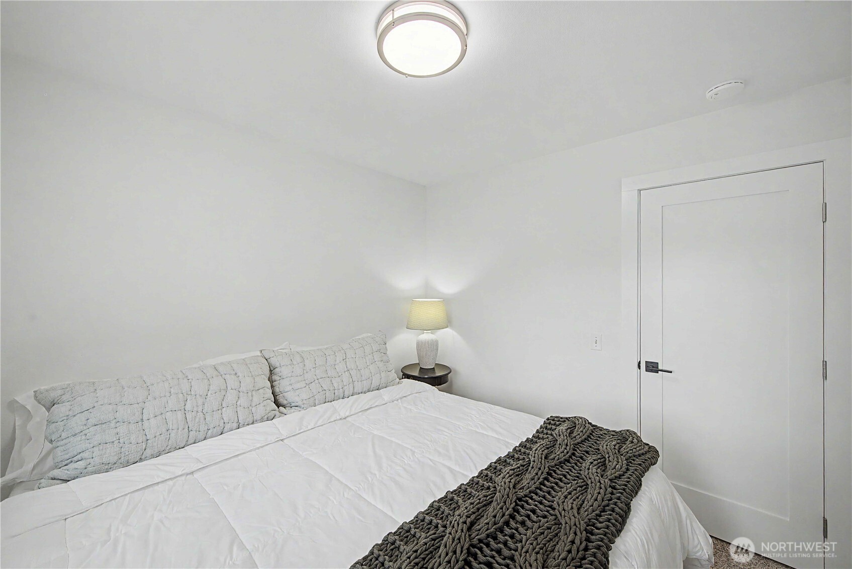 20919 Ronning Road Arlington, WA 98223 - Photo 14 of 28 a bedroom with a bed and a lamp