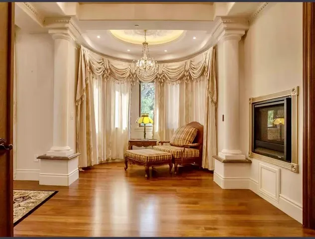 a living room with furniture and a chandelier