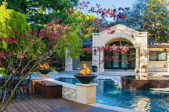swimming pool view with a seating space