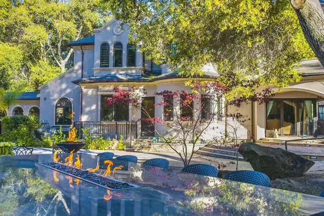 a view of house with outdoor space and sitting area