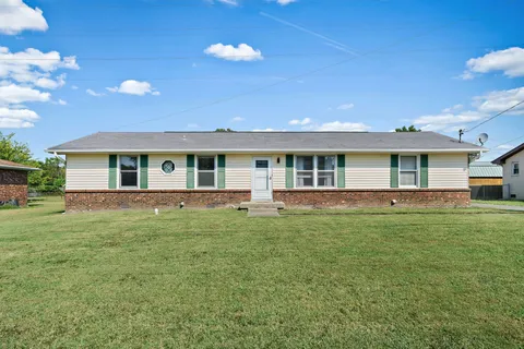 a front view of house with yard and green space